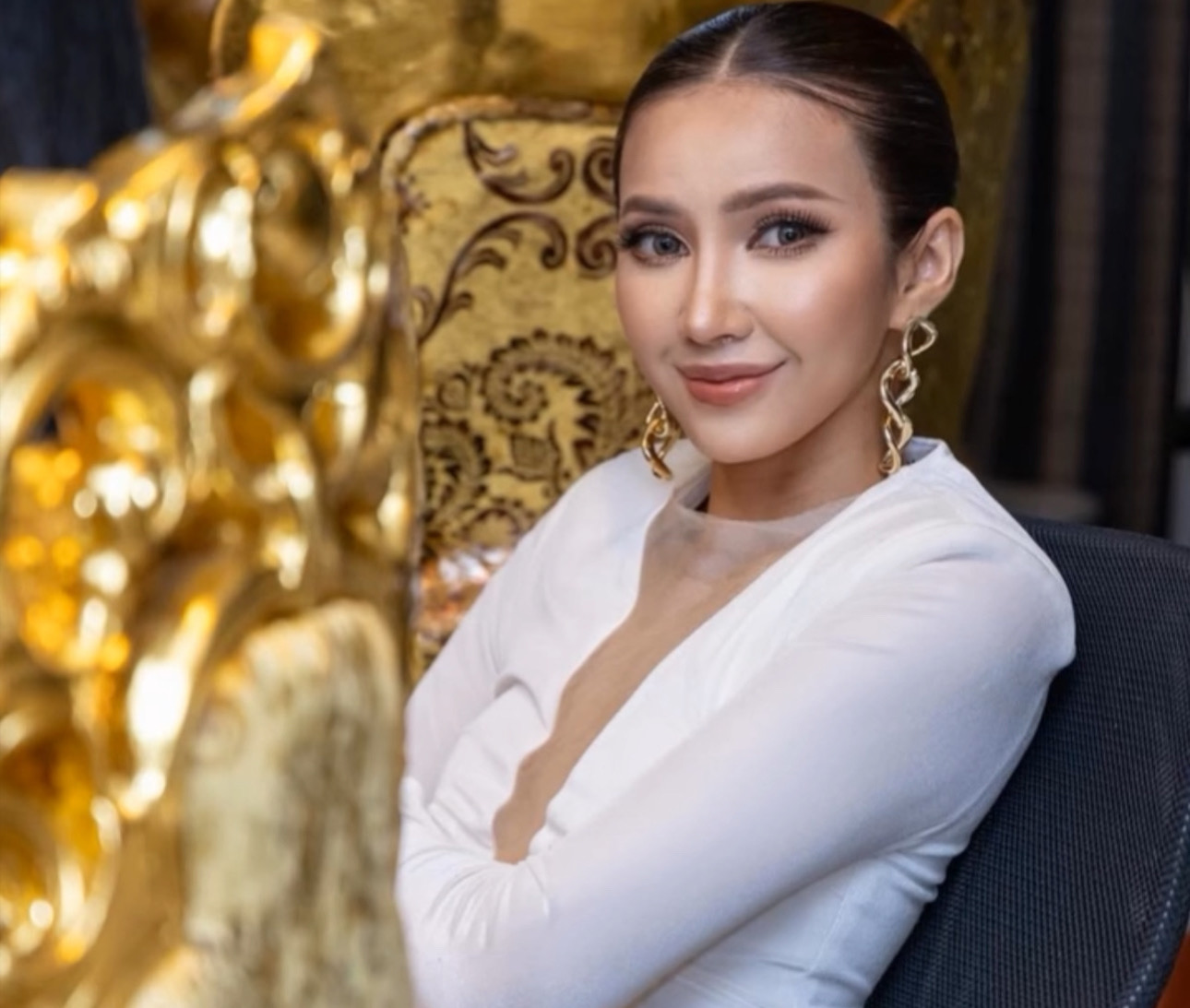 A crystal prize sits in a display case, bathed in vibrant rainbow light, exuding a sense of prestige and luxury.